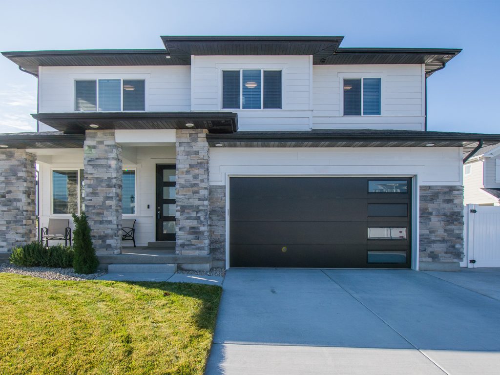 Our signature sectional garage doors, adorned with a row of windows, seamlessly blend functionality with style. The sectional design optimizes space while the addition of windows allows natural light to illuminate your garage, creating a welcoming ambiance.